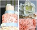 Three tiered cake in shades of coral and white with silver ribbon. Flowers and decorations are made out of buttercream and fondant. 